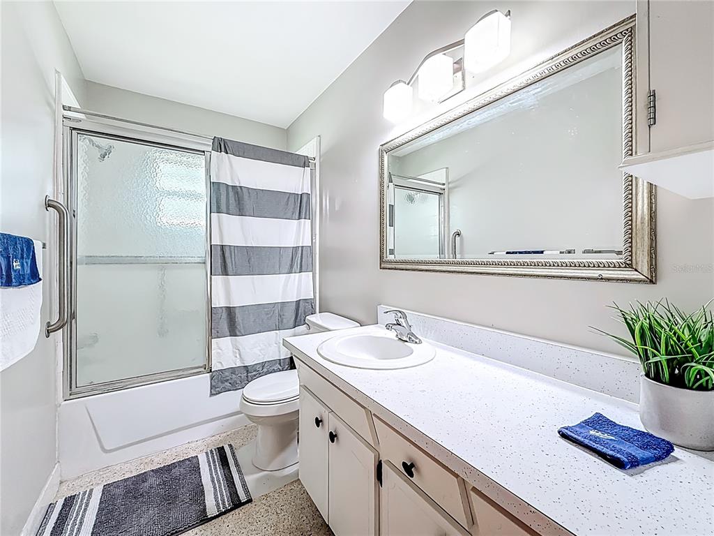 250 Rosery Road Northwest, Unit 283 Largo, FL 33770 - Photo 16 of 23 a bathroom with a sink a toilet and shower