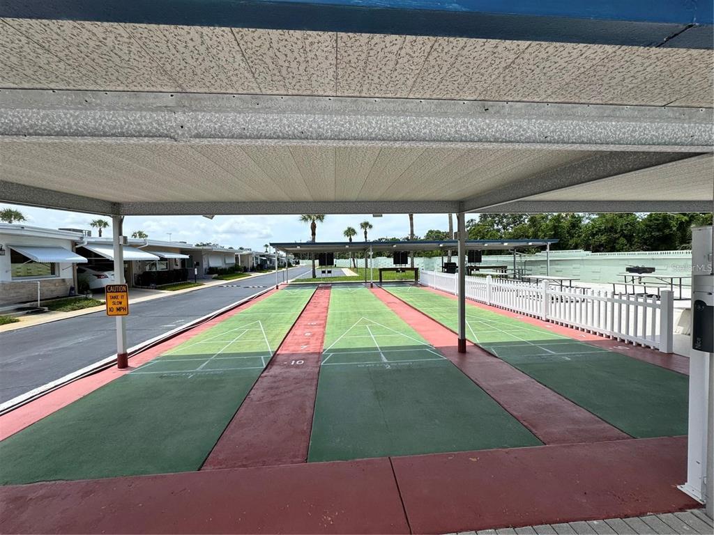 250 Rosery Road Northwest, Unit 283 Largo, FL 33770 - Photo 20 of 23 a view of yard with swimming pool and sitting area