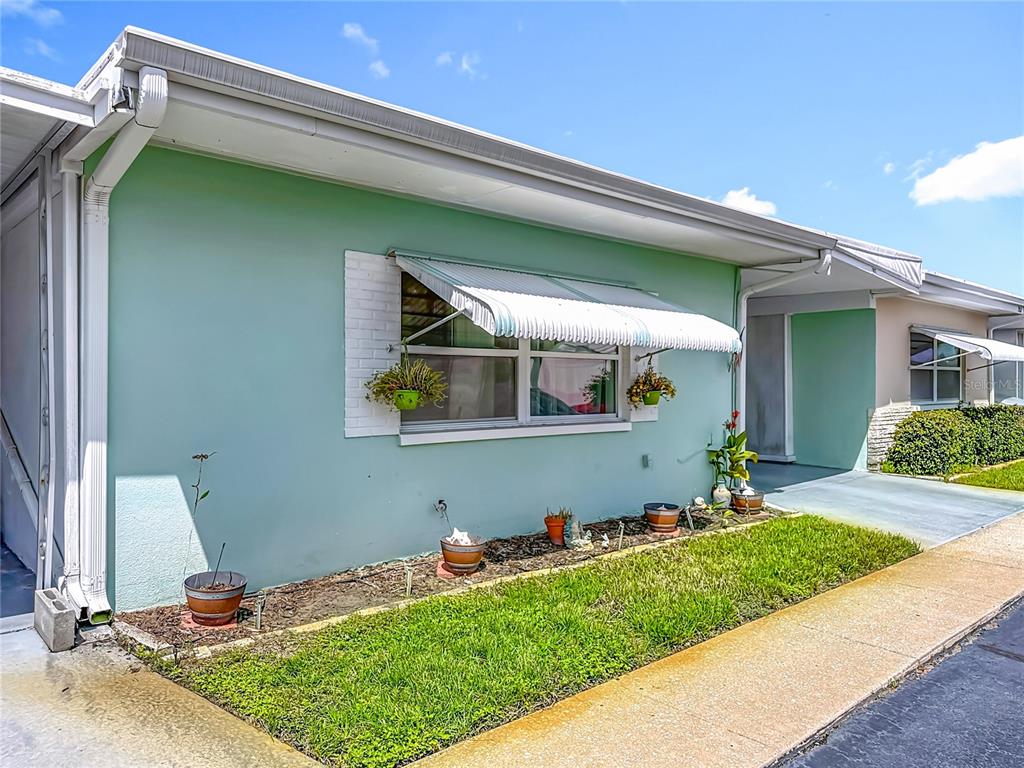 250 Rosery Road Northwest, Unit 283 Largo, FL 33770 - Photo 2 of 23 a front view of a house with a yard