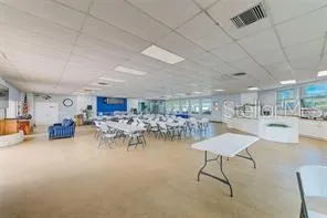 a room with pool table and chairs