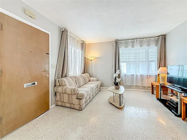 a bedroom with furniture and a large window