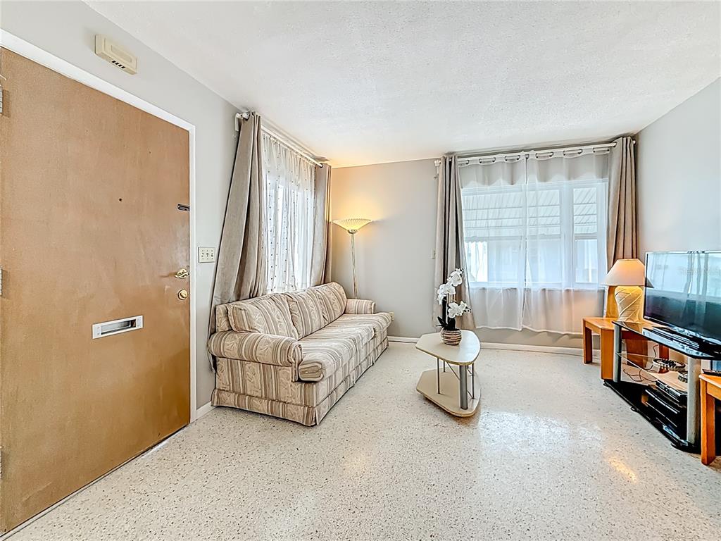 250 Rosery Road Northwest, Unit 283 Largo, FL 33770 - Photo 4 of 23 a bedroom with furniture and a large window