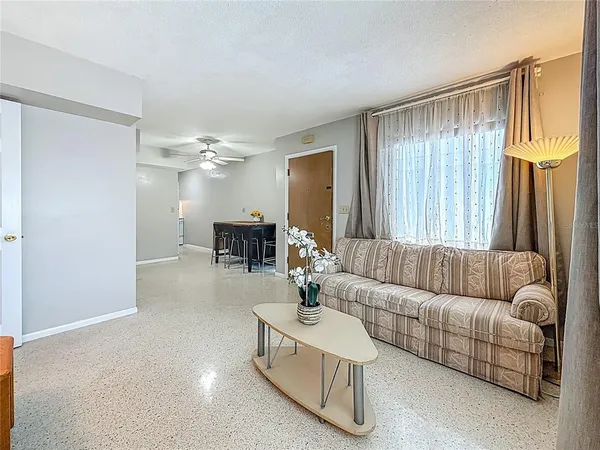 a living room with furniture and a large mirror