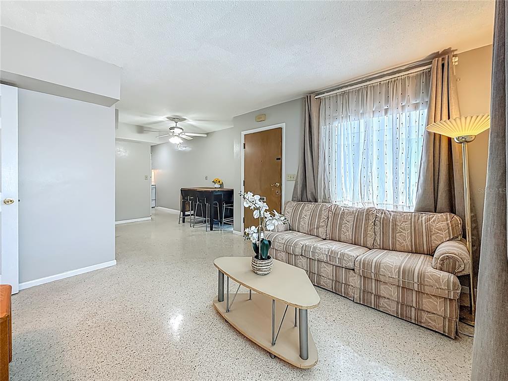250 Rosery Road Northwest, Unit 283 Largo, FL 33770 - Photo 6 of 23 a living room with furniture and a large mirror
