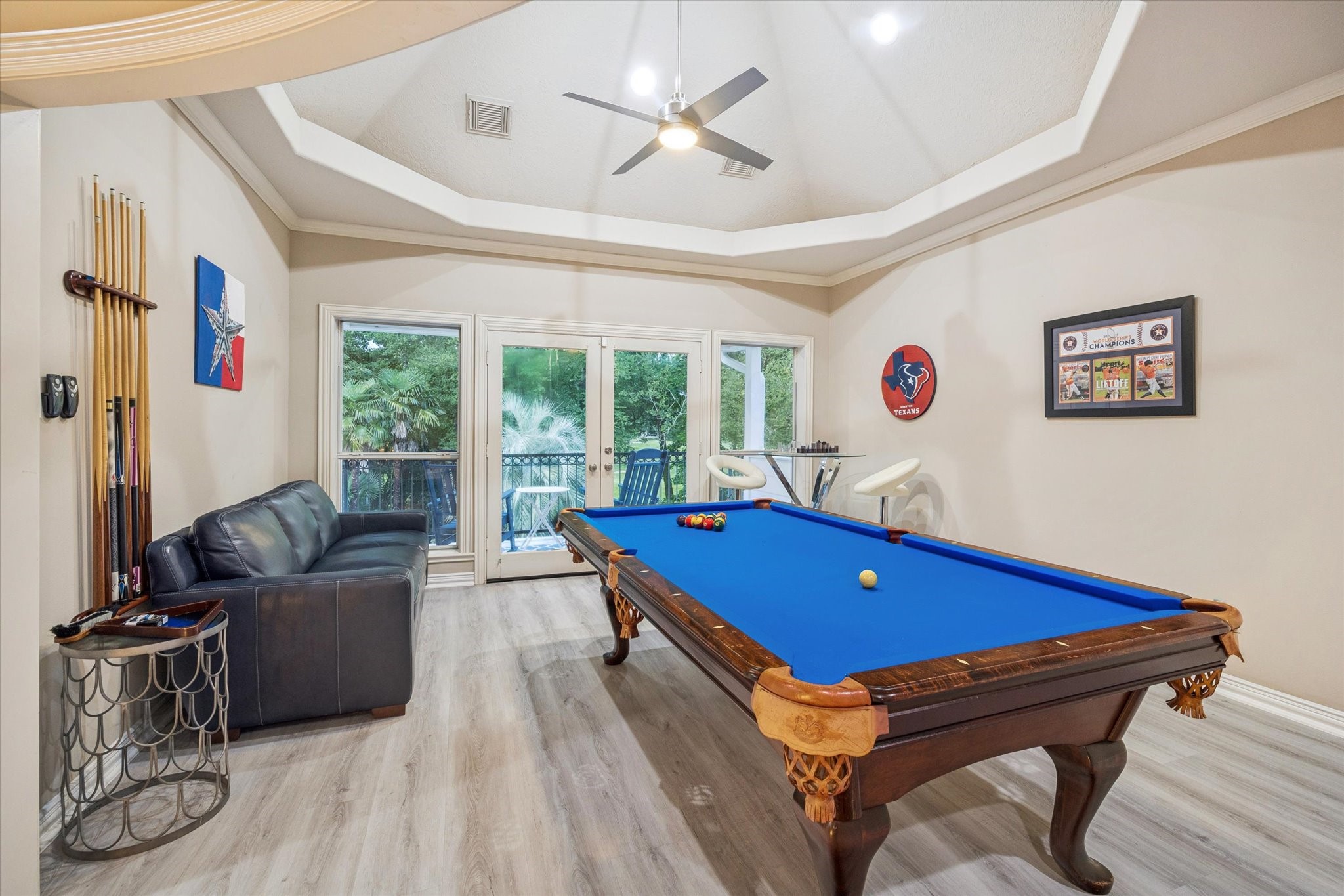 35 North Regent Oak Spring, TX 77381 - Photo 31 of 43 Enjoy endless opportunities for relaxation and entertainment in this spacious second-floor game room. Filled with natural light and enhanced by elegant tray ceilings, the space opens to a private balcony with beautiful views of the pool and backyard. A wonderful gathering place for family game nights, celebrations, or simply enjoying time together.