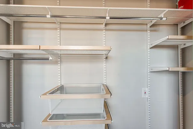 a view of kitchen with stainless steel appliances granite countertop cabinets and window