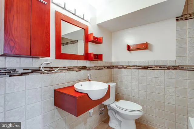 a bathroom with a white bath tub and a toilet