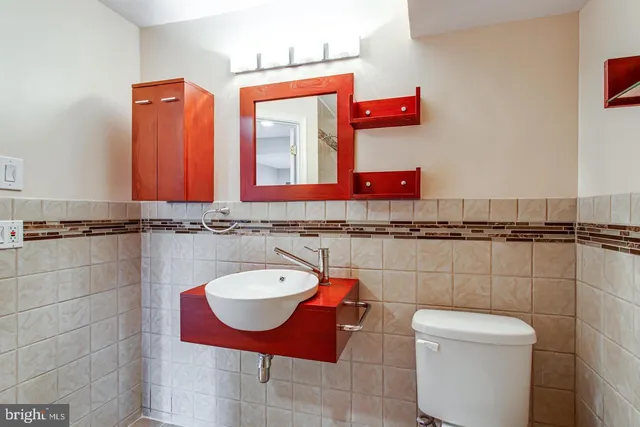 a bathroom with a sink toilet and mirror
