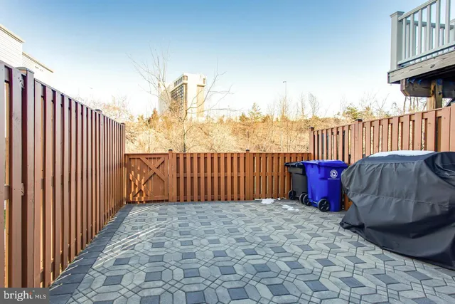 a backyard of a house with barbeque oven and outdoor seating