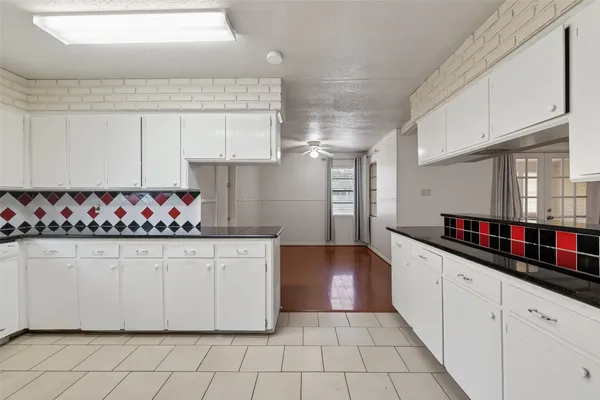 a kitchen with stainless steel appliances granite countertop a sink and cabinets