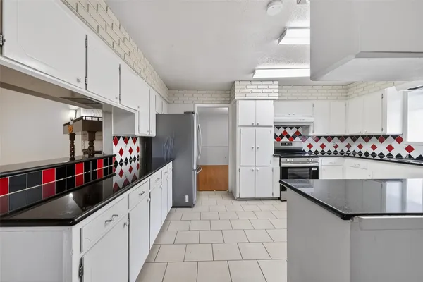 a kitchen with stainless steel appliances granite countertop a sink and cabinets