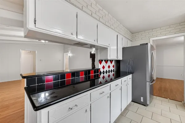 a kitchen with stainless steel appliances granite countertop a sink and cabinets