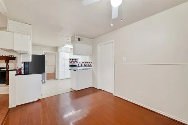 a view of kitchen with stainless steel appliances cabinets and wooden floor