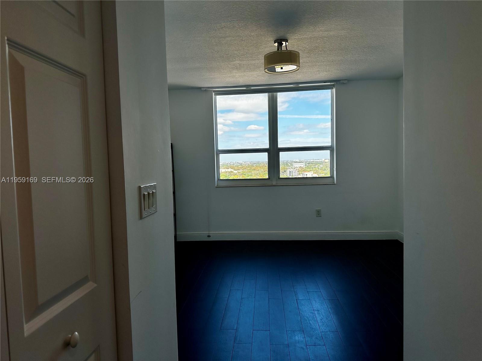 3232 Southwest 22nd Terrace, Unit 1604 Miami, FL 33145 - Photo 18 of 40 an empty room with a window
