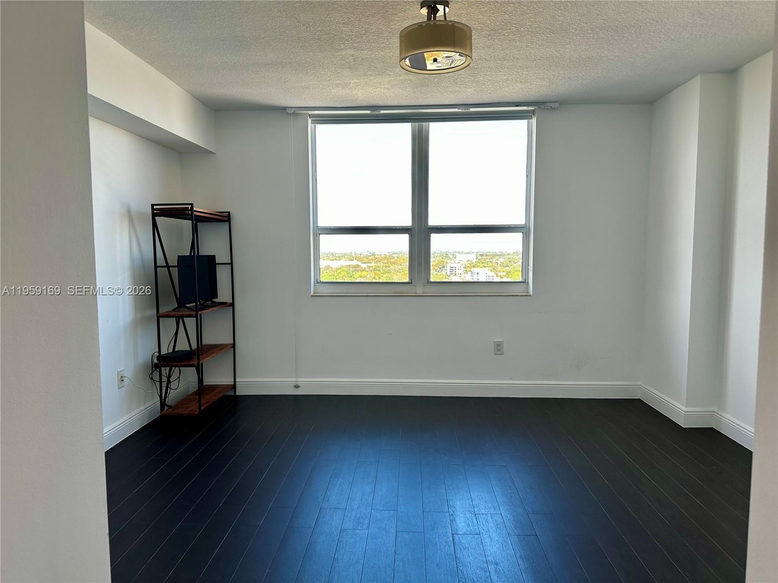 3232 Southwest 22nd Terrace, Unit 1604 Miami, FL 33145 - Photo 19 of 40 an empty room with wooden floor and windows