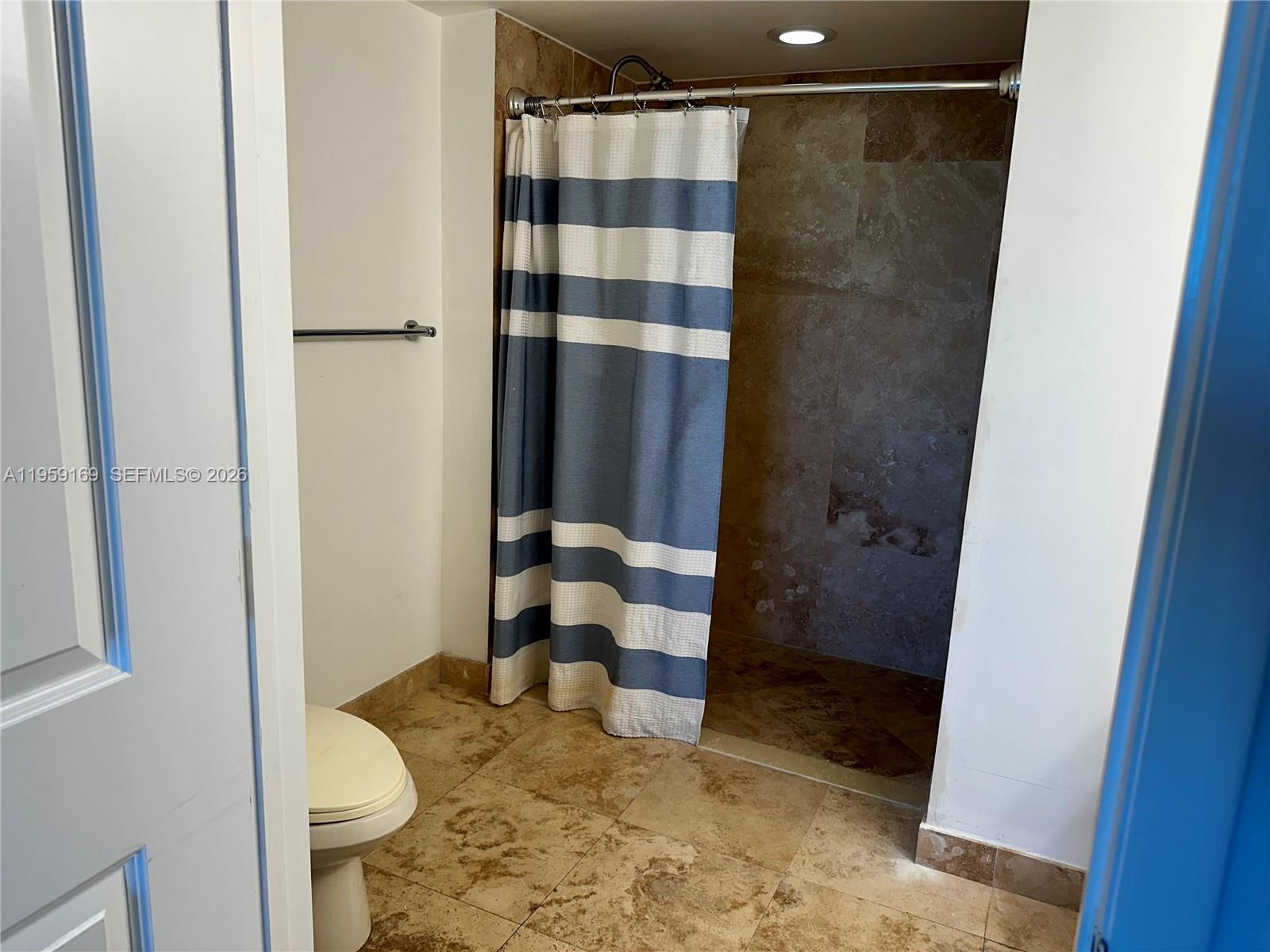 3232 Southwest 22nd Terrace, Unit 1604 Miami, FL 33145 - Photo 24 of 40 a bathroom with a granite countertop shower and a toilet