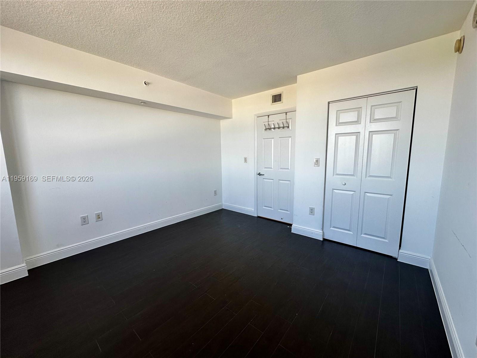 3232 Southwest 22nd Terrace, Unit 1604 Miami, FL 33145 - Photo 28 of 40 wooden floor in an empty room