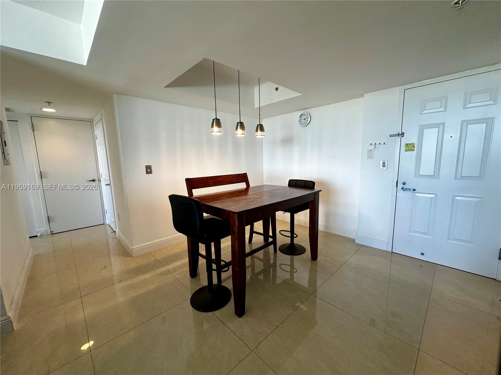 3232 Southwest 22nd Terrace, Unit 1604 Miami, FL 33145 - Photo 9 of 40 a room with stainless steel appliances kitchen island a table and chairs in it