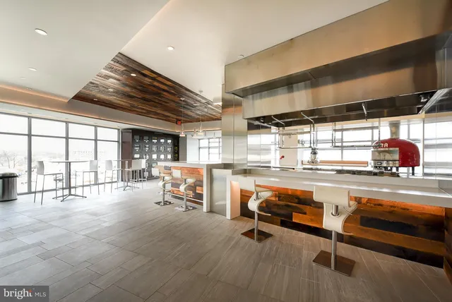 a living room with patio furniture and a large window