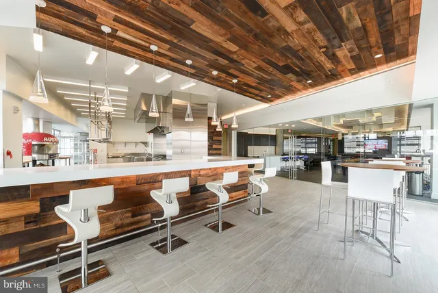 a living room with lots of furniture and a kitchen view