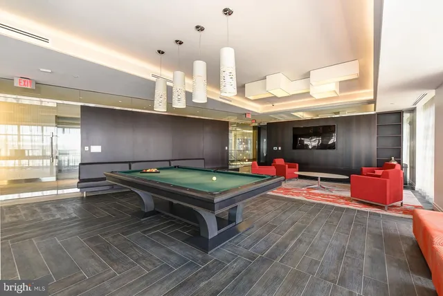 a room with pool table and flat screen tv
