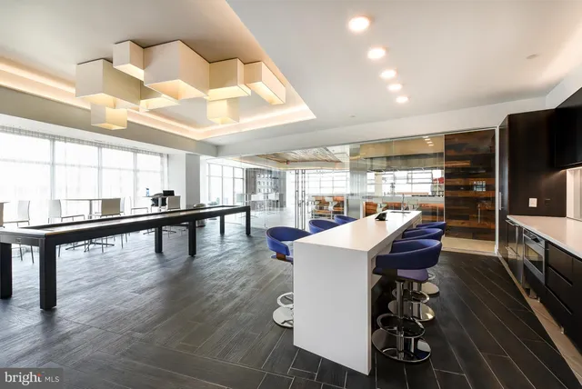a dining room with furniture and wooden floor