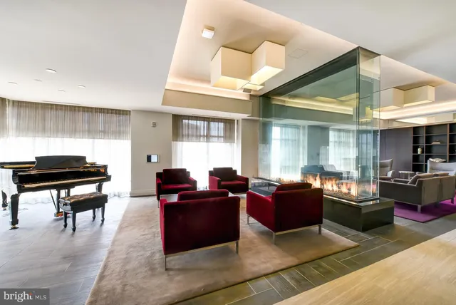 a living room with furniture a dining table and chairs with wooden floor