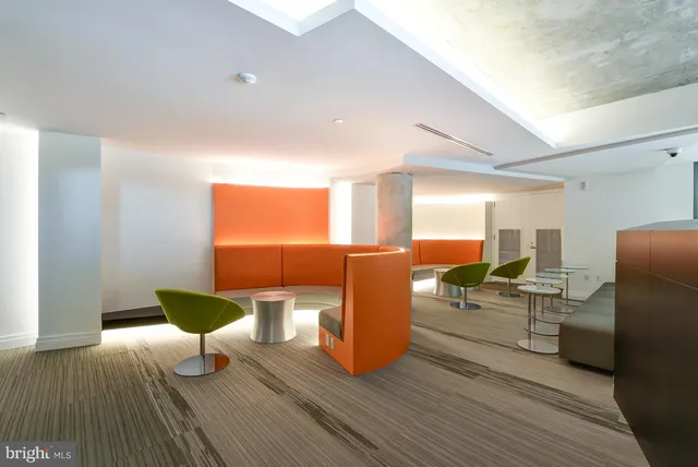 a view of an entryway with a floor to ceiling window and wooden floor