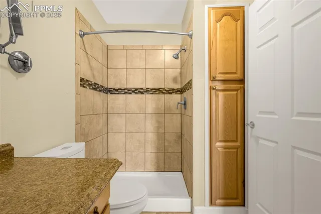 a bathroom with a toilet and shower