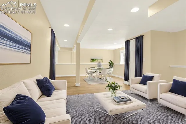 a living room with furniture rug and a table