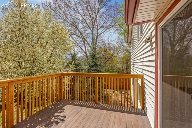 a view of balcony with wooden floor and fence