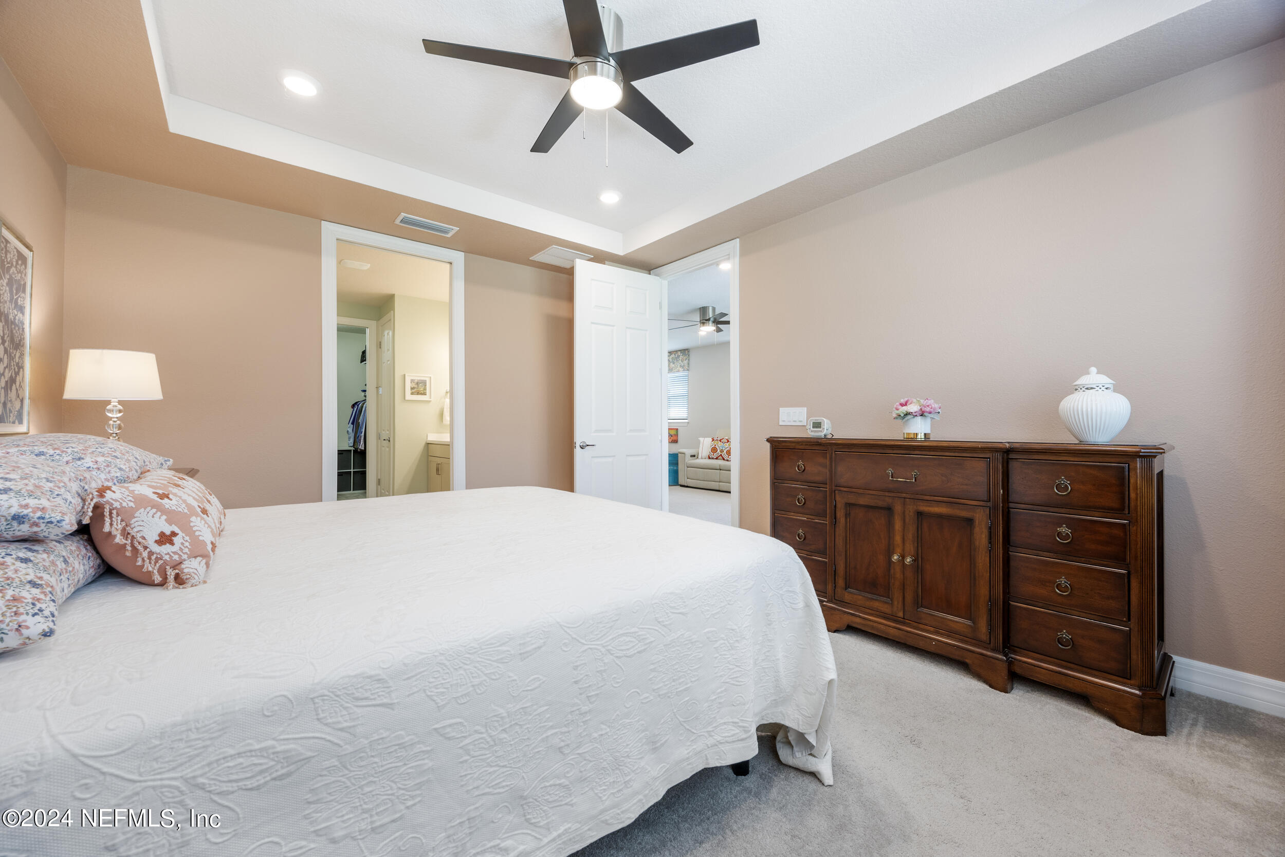 220 Rock Spg Loop St. Augustine, FL 32095 - Photo 14 of 30 a bedroom with a bed and a chandelier