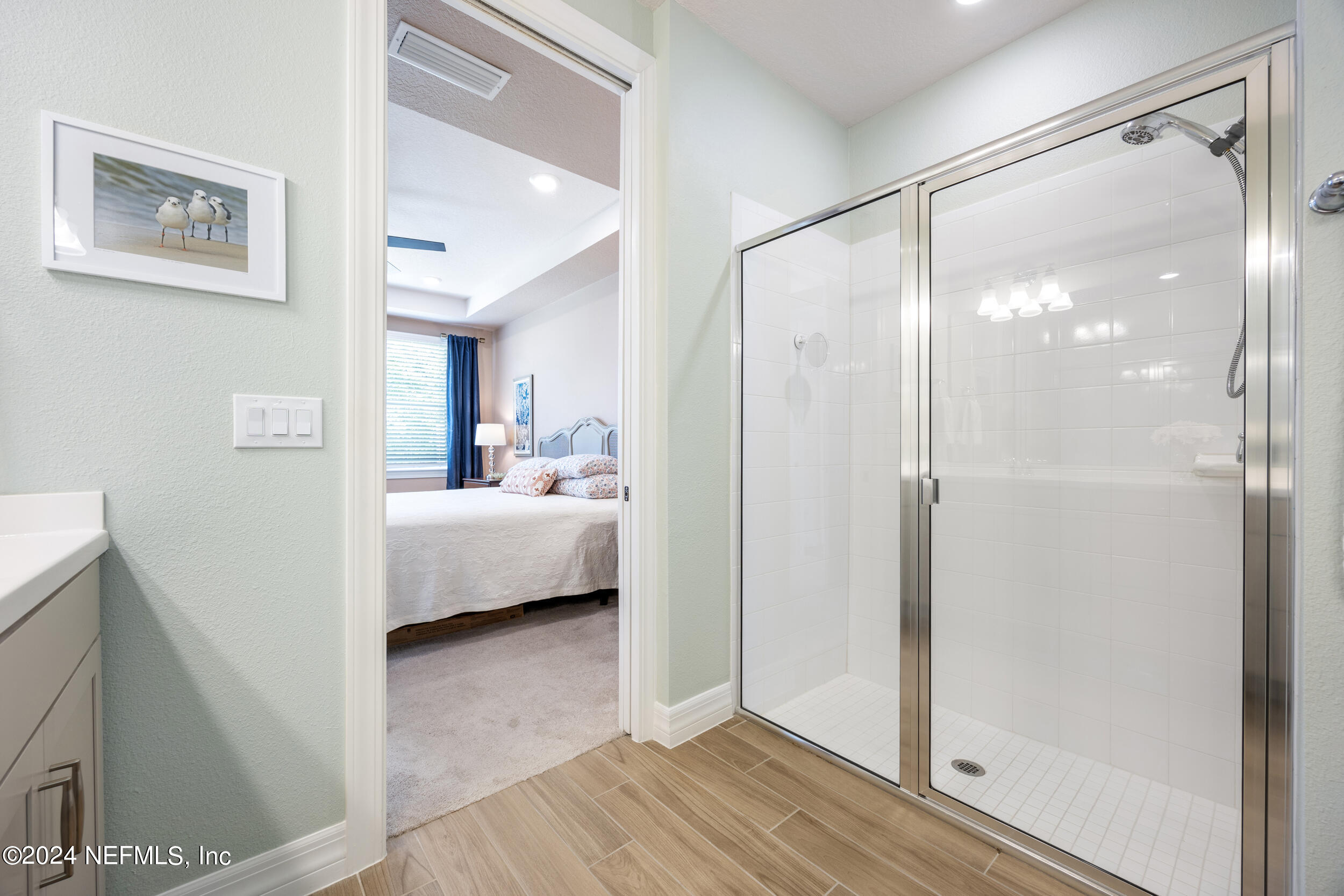 220 Rock Spg Loop St. Augustine, FL 32095 - Photo 16 of 30 a en suite bathroom with a glass shower door and a sink