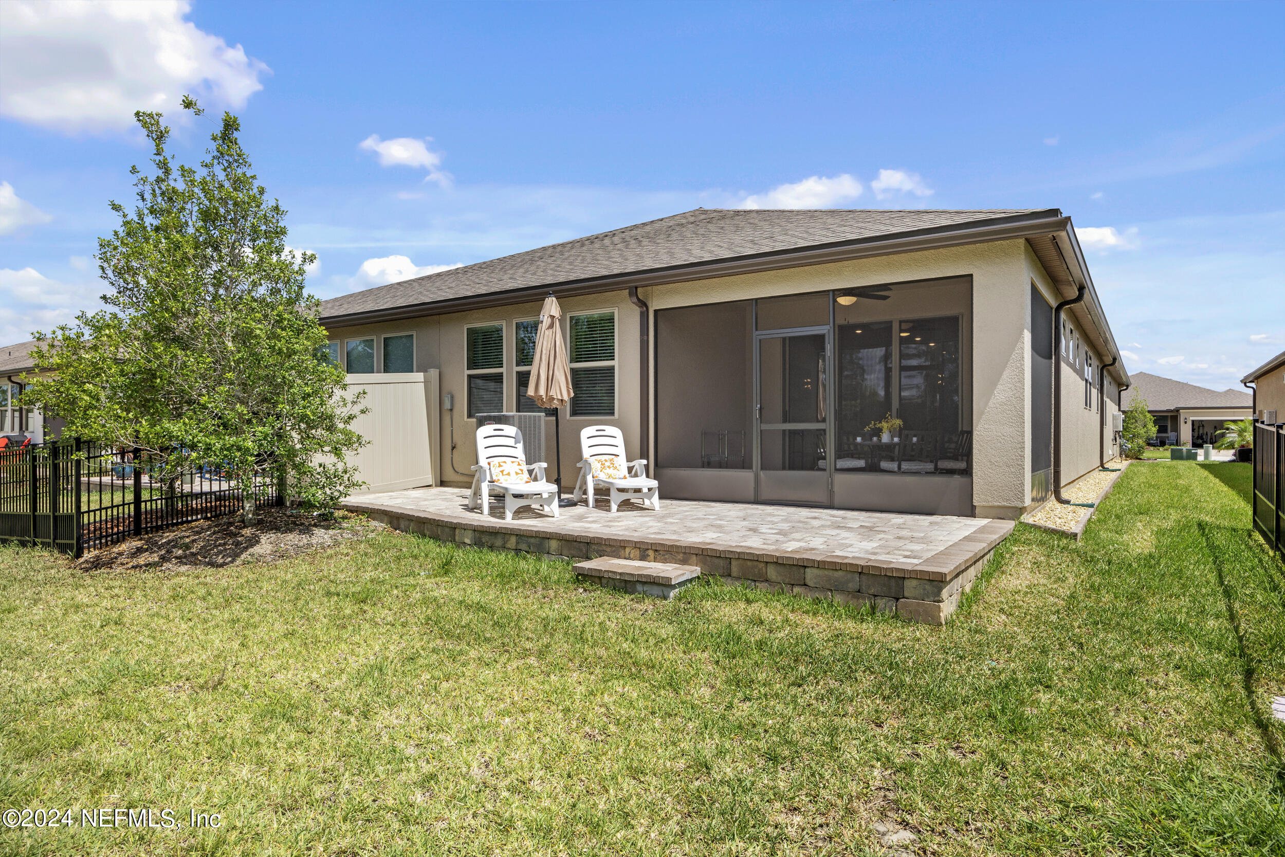 220 Rock Spg Loop St. Augustine, FL 32095 - Photo 25 of 30 a front view of a house with a yard table and chairs