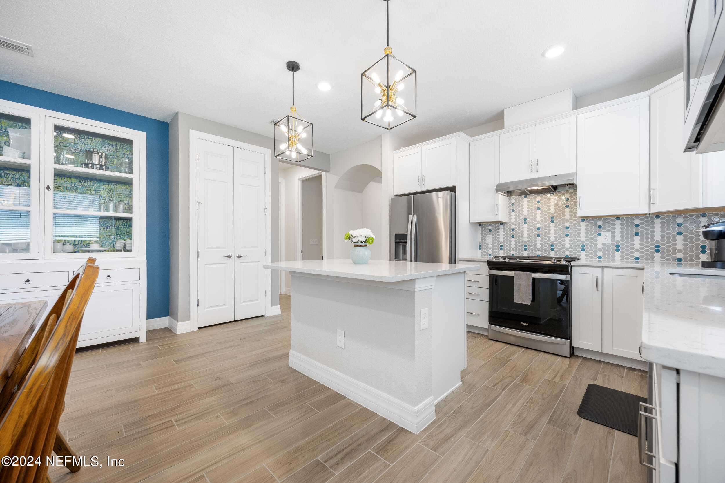 220 Rock Spg Loop St. Augustine, FL 32095 - Photo 8 of 30 a large kitchen with cabinets wooden floor and stainless steel appliances