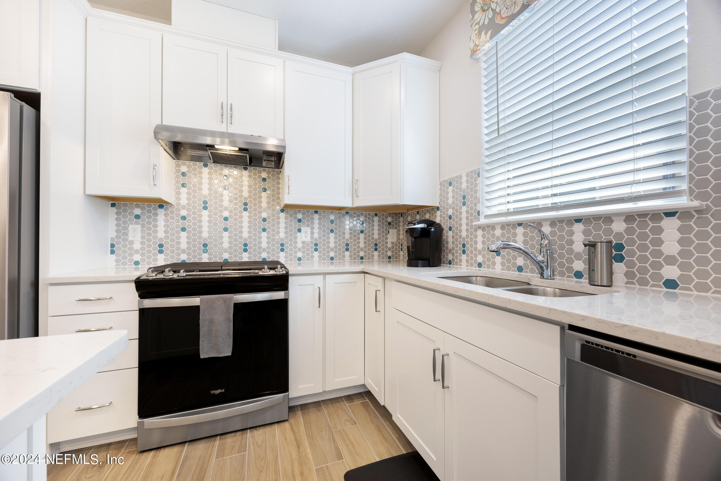 220 Rock Spg Loop St. Augustine, FL 32095 - Photo 9 of 30 a kitchen with stainless steel appliances white cabinets and a stove a sink