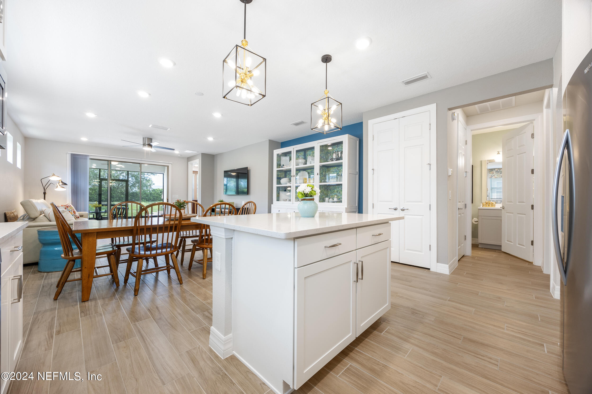 220 Rock Spg Loop St. Augustine, FL 32095 - Photo 27 of 30 a kitchen with stainless steel appliances granite countertop a stove oven a kitchen island a dining table and chairs
