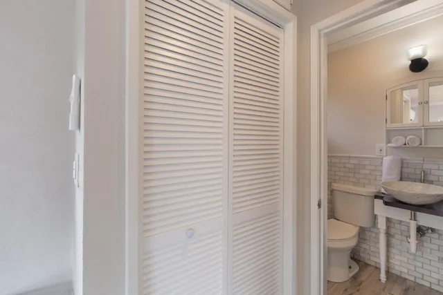 a bathroom with a toilet a sink and shower