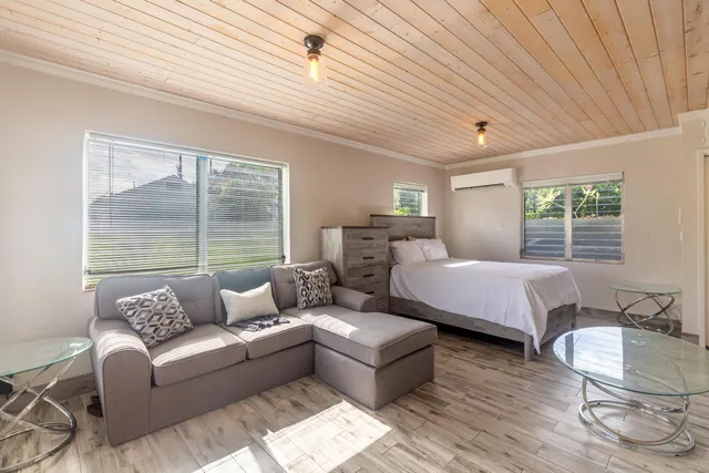 a bedroom with furniture and a large window