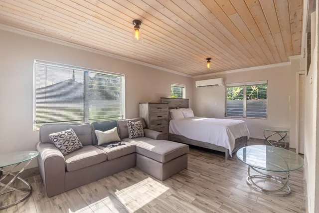 a bedroom with furniture and a large window