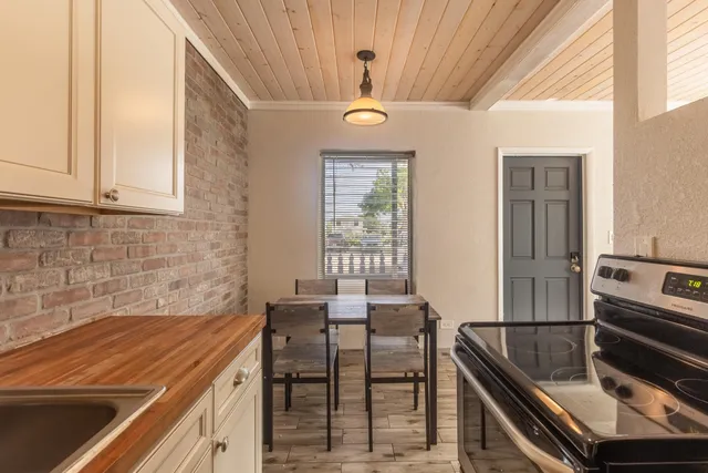 a kitchen with stainless steel appliances granite countertop a sink and a stove
