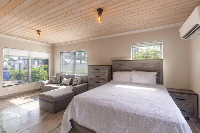 a bedroom with a bed couch and window