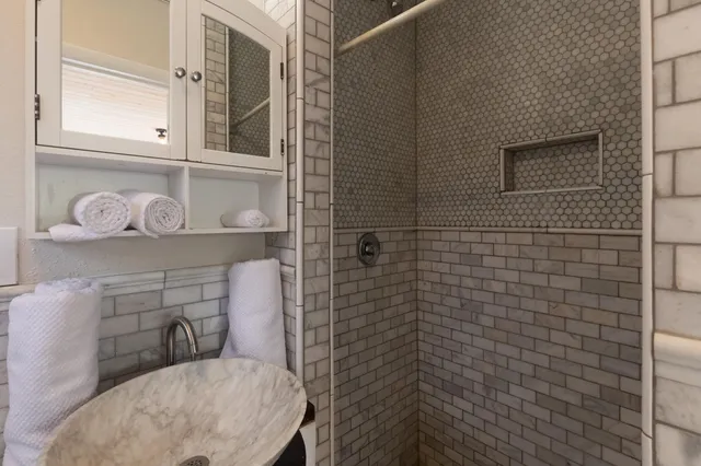 a bathroom with a sink toilet and shower