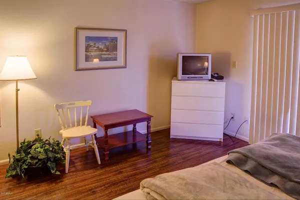 a view of a workspace room with furniture and wooden floor