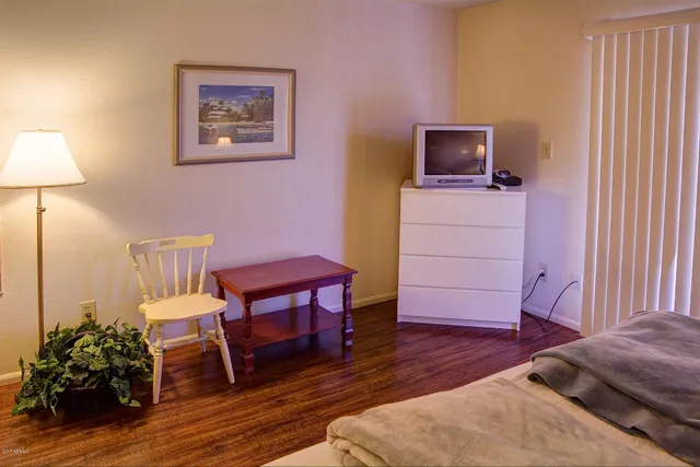 a view of a workspace room with furniture and wooden floor