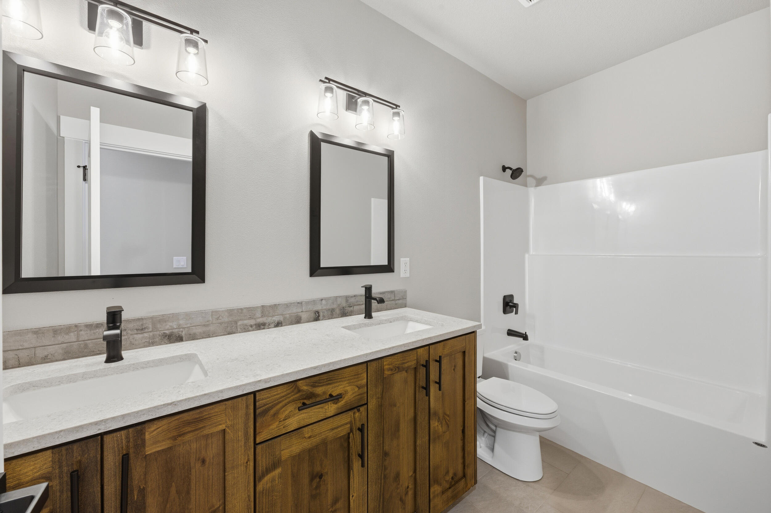 16083 Dyke Road, Unit 9 La Pine, OR 97739 - Photo 33 of 53 a bathroom with a double vanity sink mirror double and toilet