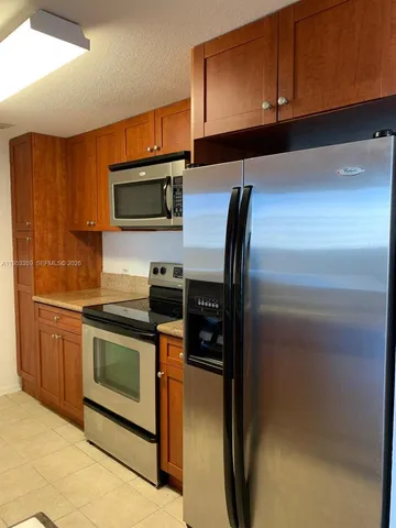 a kitchen with granite countertop stainless steel appliances and cabinets