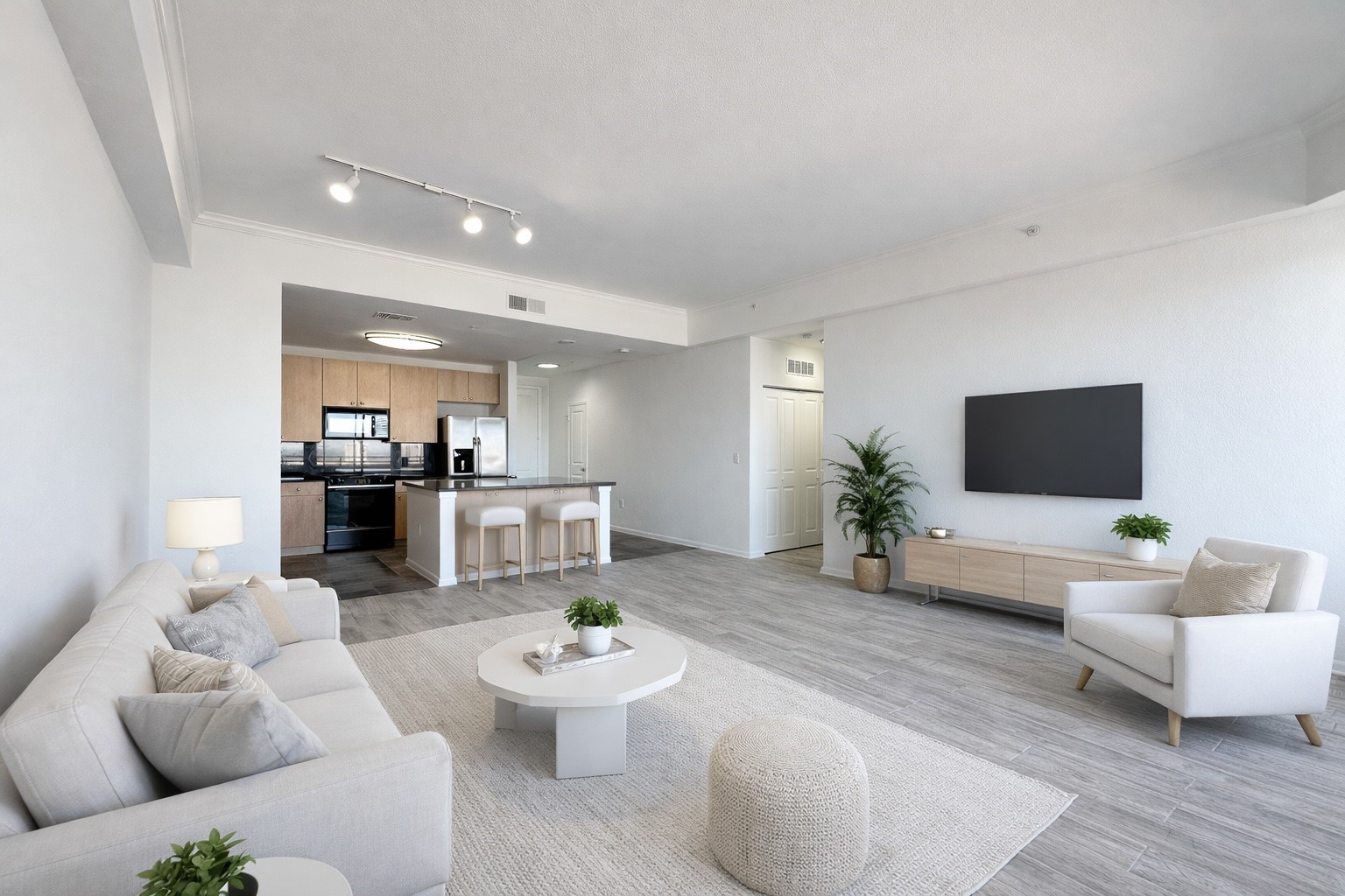 a living room with furniture and a view of kitchen