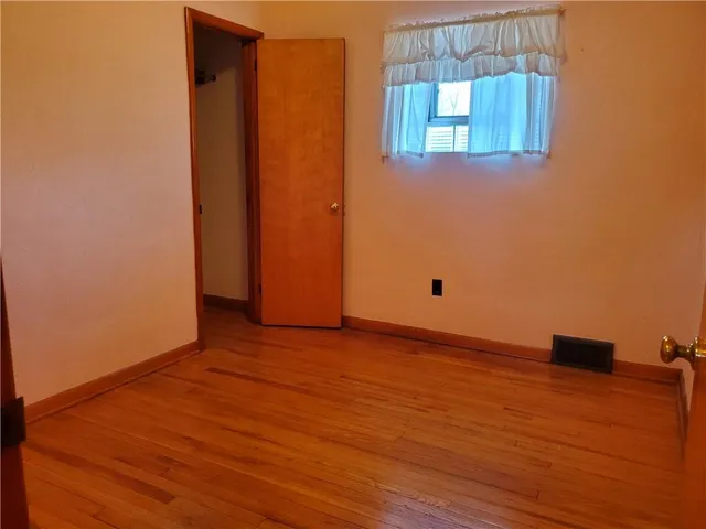 a view of a room with wooden floor and window
