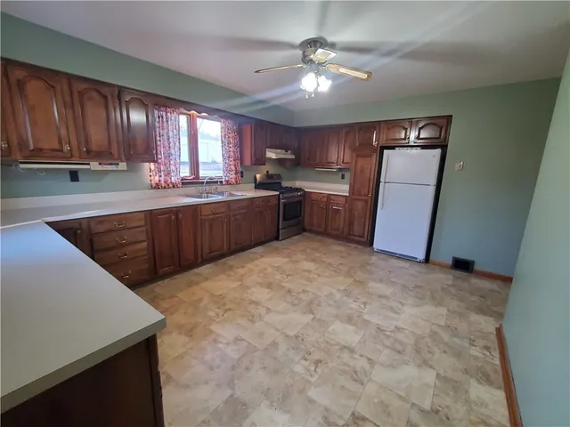 a kitchen with stainless steel appliances granite countertop a stove sink and cabinets